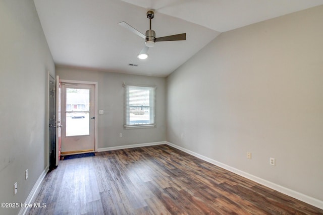 empty room with dark hardwood / wood-style floors, ceiling fan, and lofted ceiling