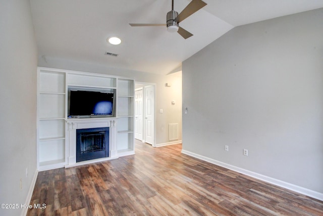 unfurnished living room with ceiling fan, built in features, hardwood / wood-style floors, and vaulted ceiling