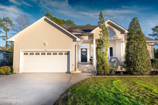 view of front of home featuring a garage and a front lawn