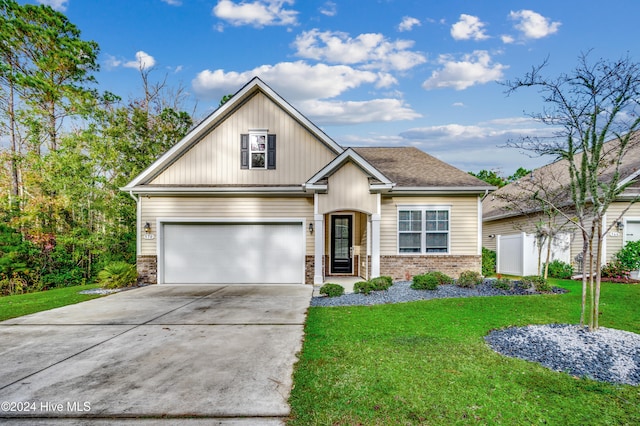 view of front of home featuring a front yard and a garage