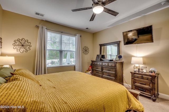 bedroom with ceiling fan and light colored carpet