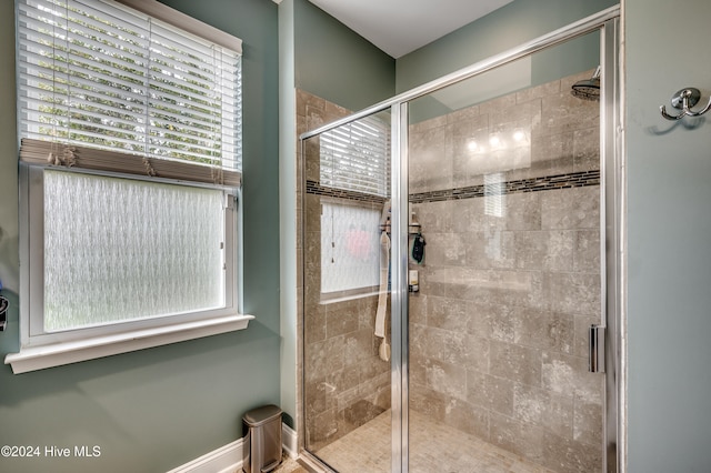 bathroom featuring a shower with door