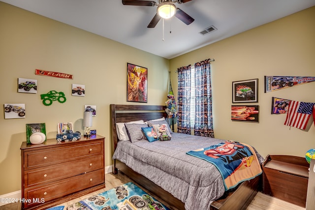 bedroom with ceiling fan and light hardwood / wood-style floors