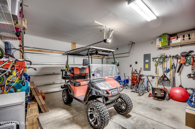 garage with a garage door opener and electric panel