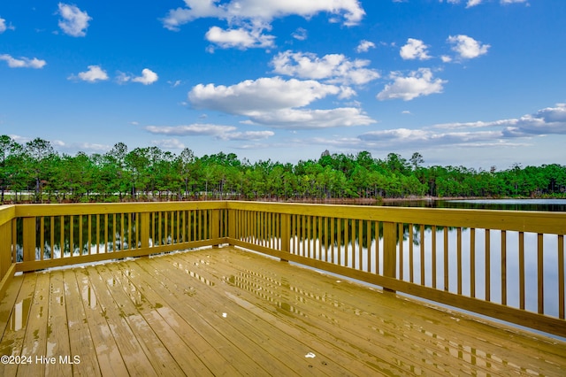 wooden terrace featuring a water view