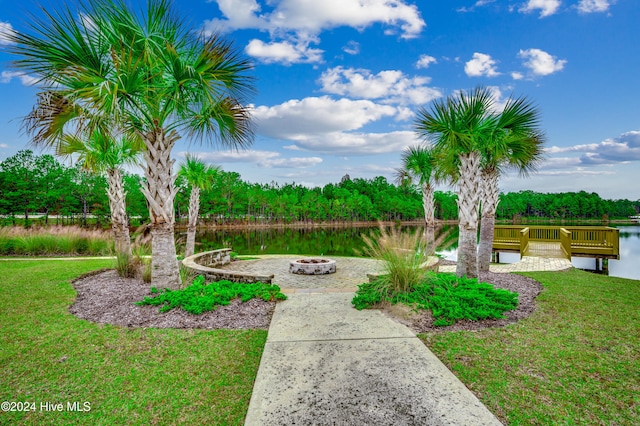 view of yard with a fire pit and a water view