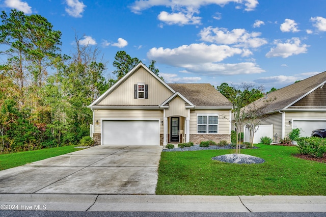 view of front of property with a garage and a front lawn