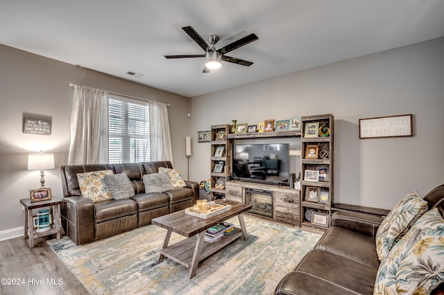 living room featuring ceiling fan and light hardwood / wood-style flooring