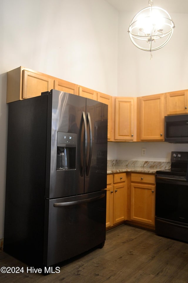 kitchen with electric range, light brown cabinets, dark wood-type flooring, stainless steel refrigerator with ice dispenser, and a notable chandelier