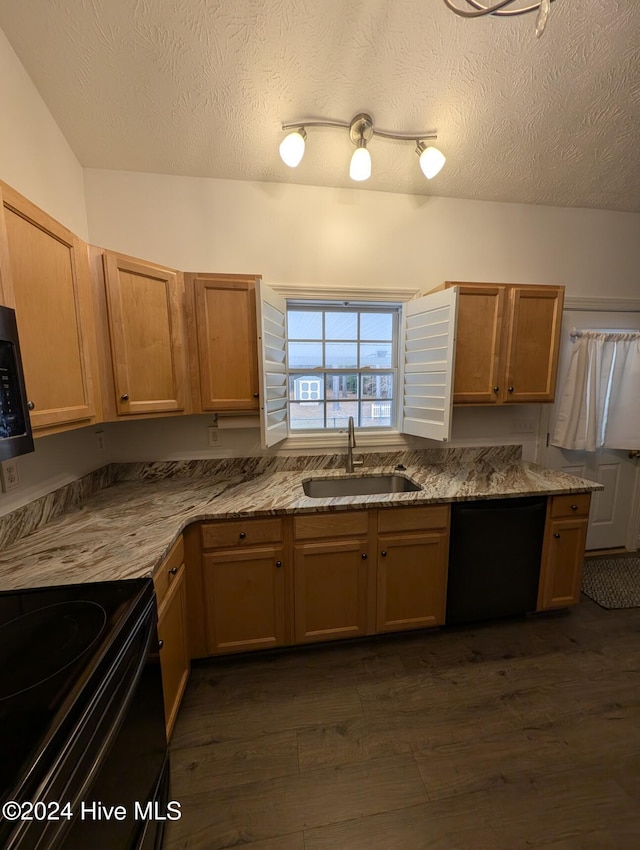 kitchen with dark hardwood / wood-style flooring, sink, black appliances, and a textured ceiling