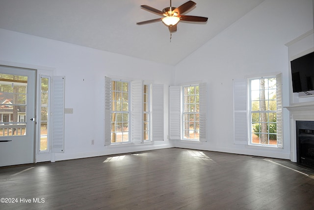 unfurnished living room with ceiling fan, dark wood-type flooring, and high vaulted ceiling