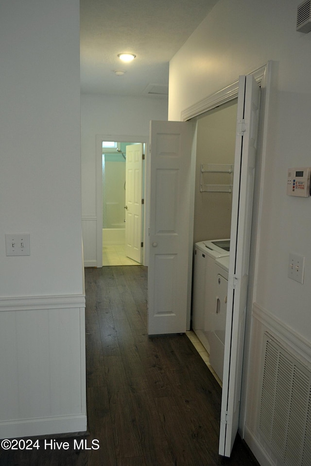 corridor featuring separate washer and dryer and dark wood-type flooring