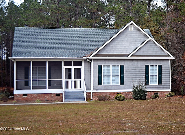 view of front facade featuring a sunroom and a front yard