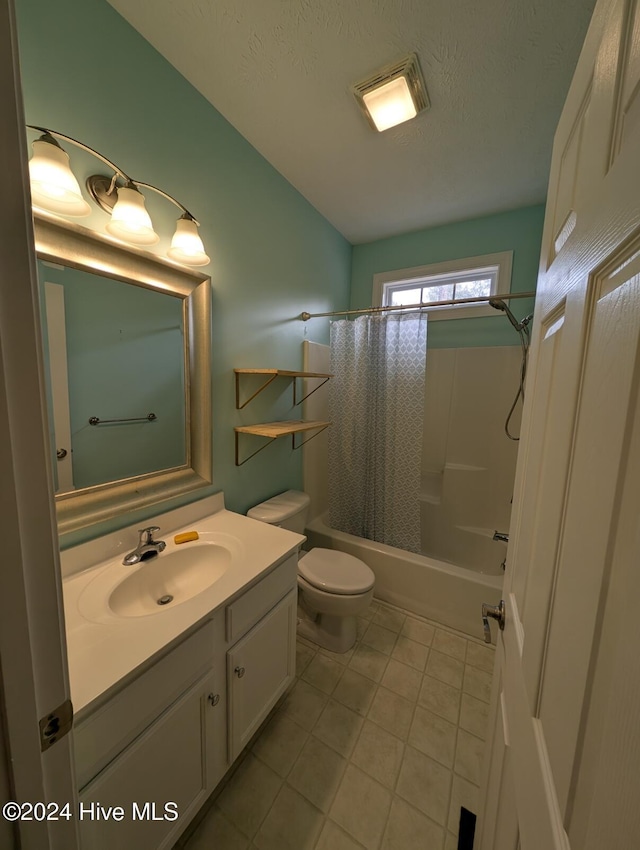 full bathroom featuring shower / bath combo, tile patterned floors, a textured ceiling, toilet, and vanity