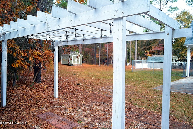 view of yard with a pergola and a storage shed