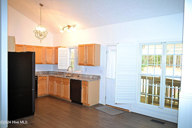 kitchen with sink, light stone counters, dark hardwood / wood-style flooring, decorative light fixtures, and black appliances