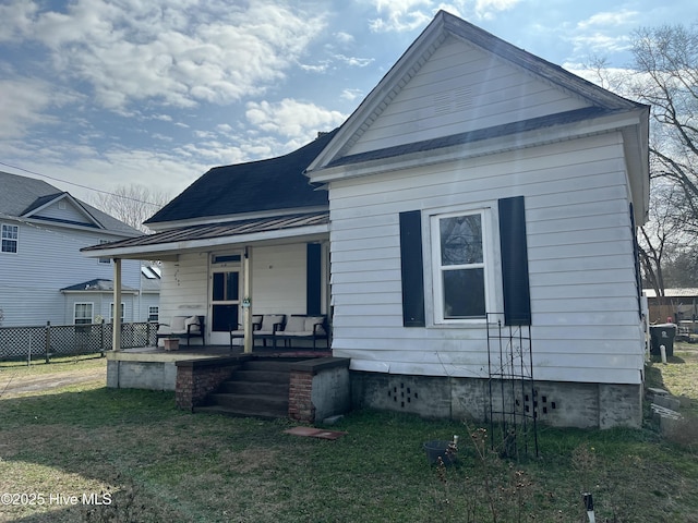 exterior space featuring a yard and covered porch