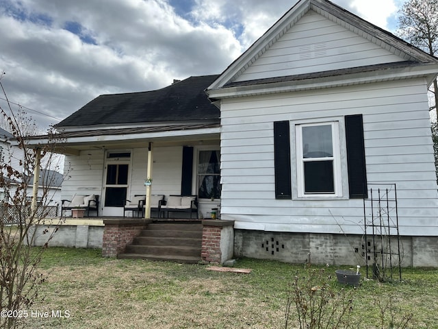 bungalow-style home featuring a porch and a front yard