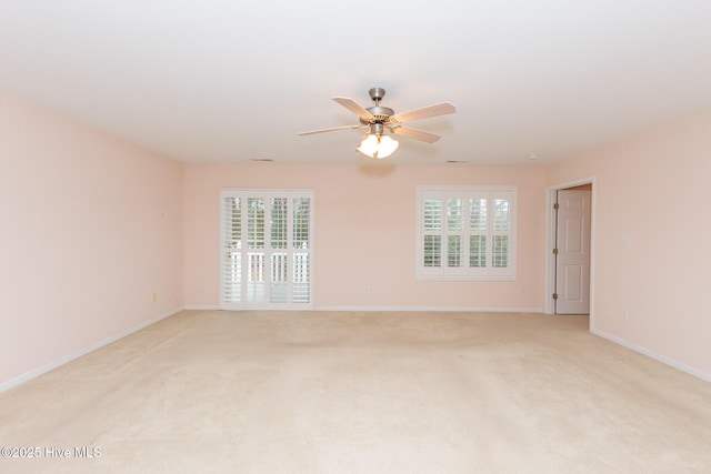 unfurnished room with light colored carpet and ceiling fan