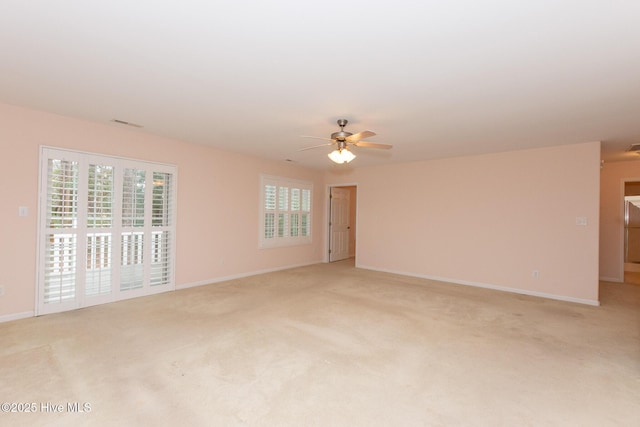 carpeted empty room featuring ceiling fan