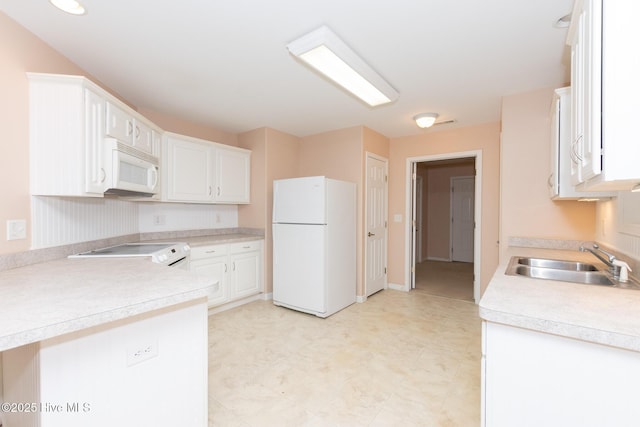 kitchen with white cabinets, white appliances, and sink