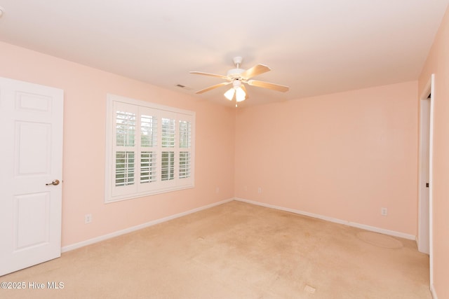 carpeted empty room featuring ceiling fan