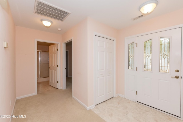 entrance foyer with light colored carpet