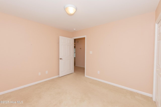 spare room with light colored carpet