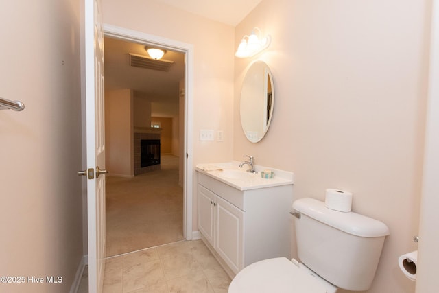 bathroom featuring tile patterned flooring, vanity, and toilet