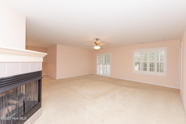 unfurnished living room with light colored carpet and ceiling fan