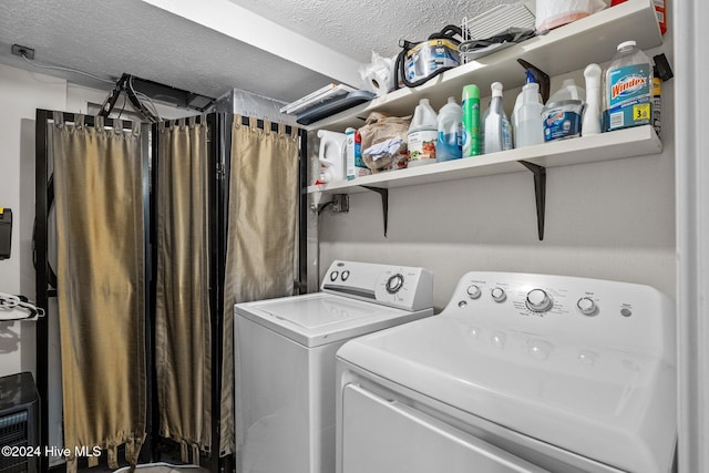 washroom featuring washer and dryer and a textured ceiling