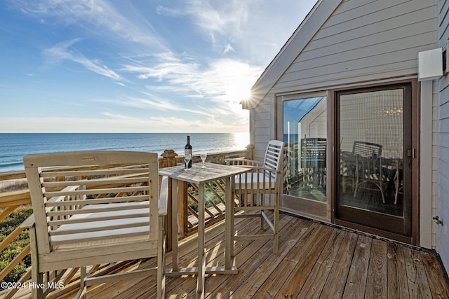 deck with a water view and a beach view