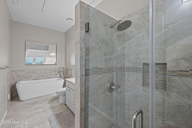 full bathroom featuring vanity, separate shower and tub, and toilet