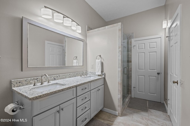 bathroom with vanity and a shower with door