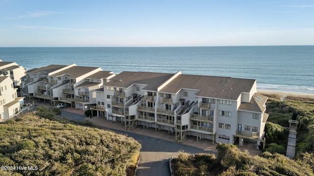 birds eye view of property with a water view and a view of the beach