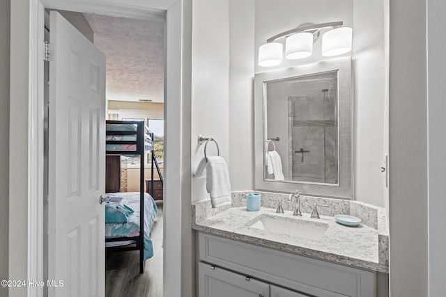 bathroom with hardwood / wood-style floors and vanity