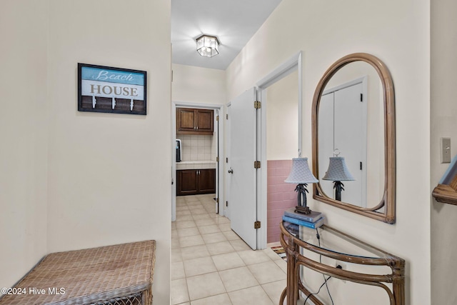 kitchen featuring tile counters, tasteful backsplash, kitchen peninsula, ceiling fan with notable chandelier, and appliances with stainless steel finishes