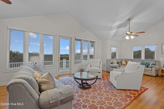 living room featuring ceiling fan, hardwood / wood-style floors, a healthy amount of sunlight, and lofted ceiling