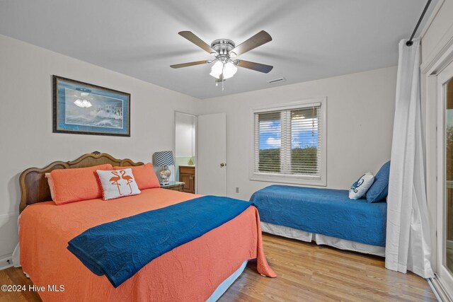 bedroom with light hardwood / wood-style flooring and ceiling fan