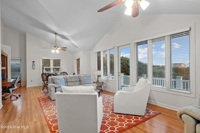 living room featuring ceiling fan, high vaulted ceiling, and light hardwood / wood-style floors