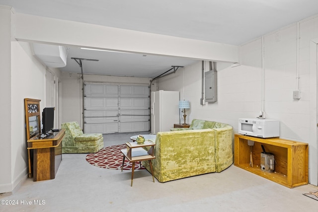 garage featuring electric panel and white fridge