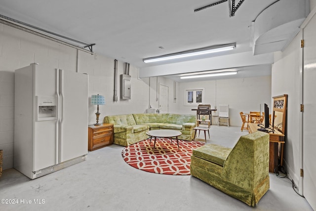 living room featuring concrete flooring and electric panel