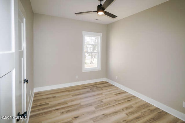 unfurnished room with baseboards, light wood-style floors, and ceiling fan