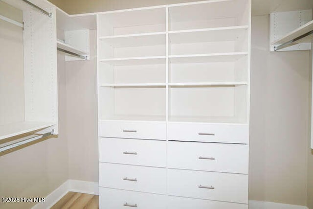 walk in closet featuring light wood-style flooring