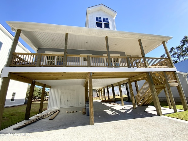 view of parking / parking lot with stairs, a carport, and driveway