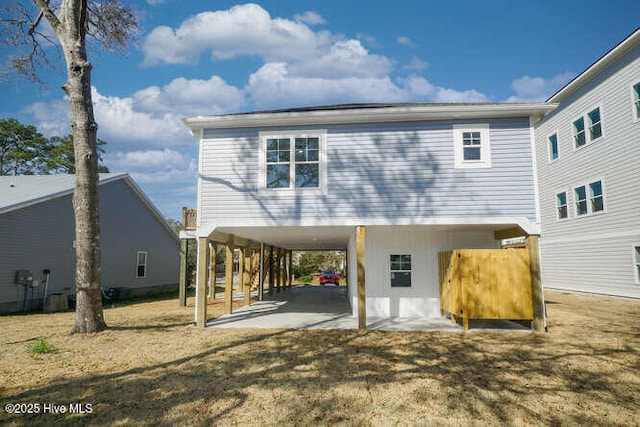 back of house with a carport and a patio area