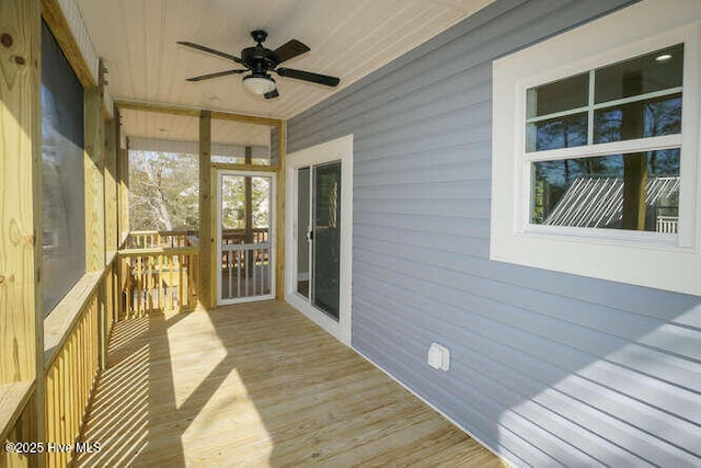 wooden terrace with a ceiling fan