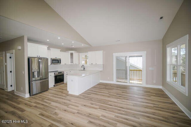 unfurnished bedroom with light hardwood / wood-style floors and ceiling fan