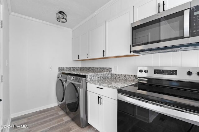 kitchen with stainless steel appliances, light hardwood / wood-style flooring, independent washer and dryer, crown molding, and white cabinets