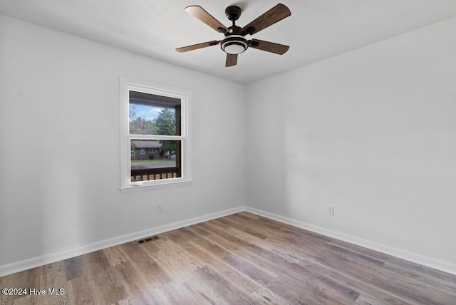 empty room featuring ceiling fan and light hardwood / wood-style floors